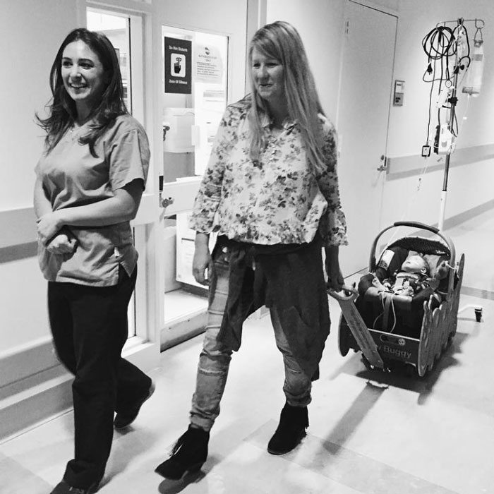 Nurse Danielle Burpee walking down a hospital hallway Alissa and Dashiel