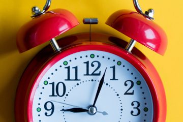 A red clock against a yellow background