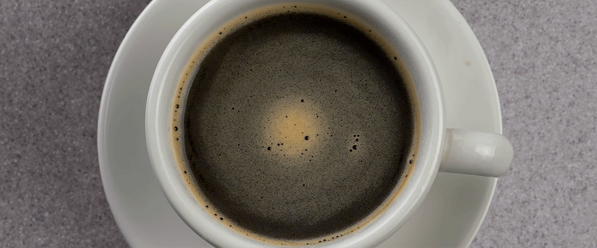 Coffee swirling in a white mug