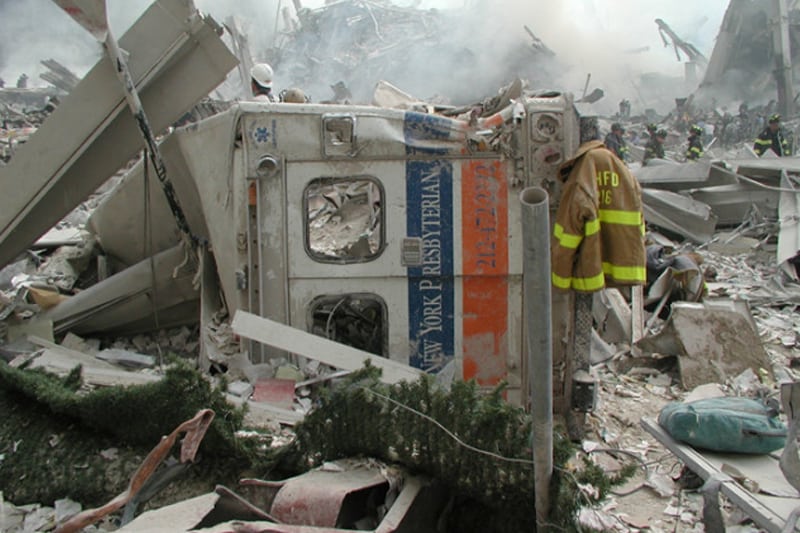 A destroyed emergency vehicle in a pile of rubble