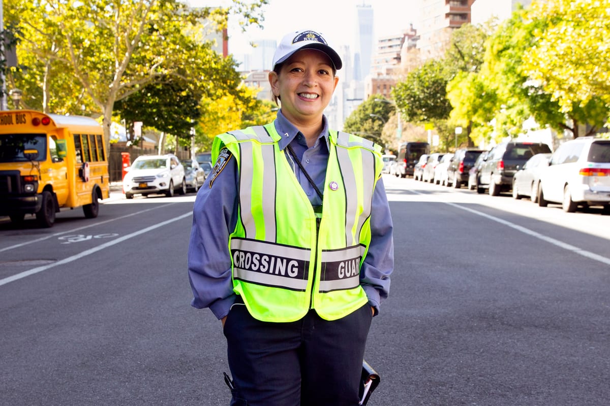 A female crossing guard smiling