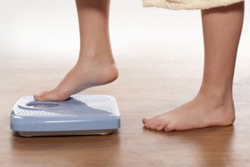 Feet stepping on a scale