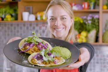 Heart-healthy cooking expert Chef Emilie Berner holding her Chicken Tinga Taco dish