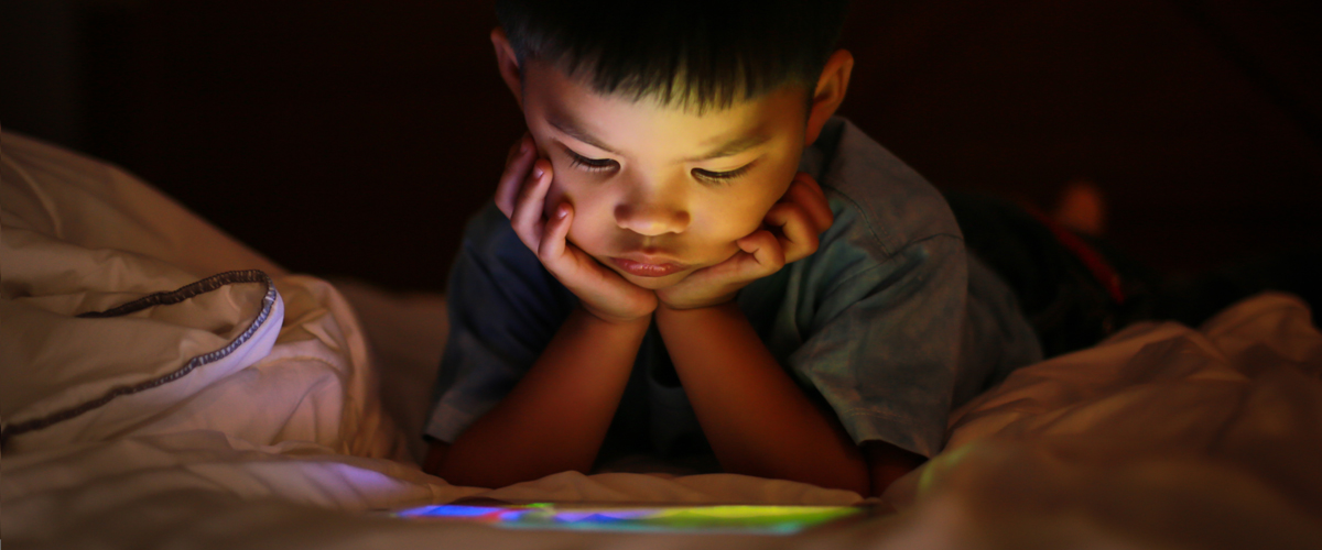 Young boy looking at a screen