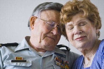Elderly war veteran with wife.