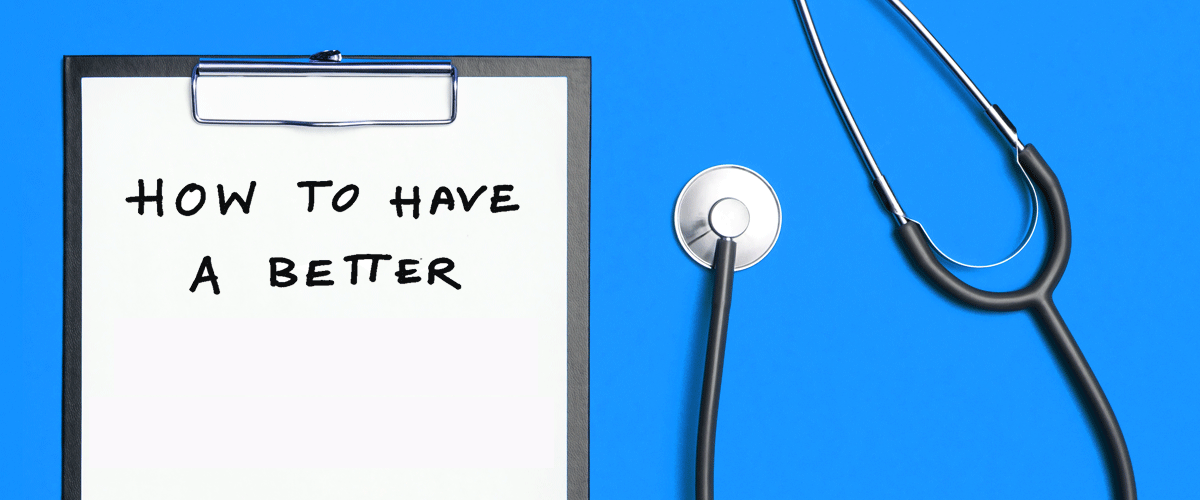 The words How to Have a Better Colonoscopy appear on a clipboard next to a stethoscope on a blue background.