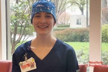 A nurse dressed in scrubs shares a message of thanks