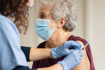 Woman gets COVID-19 vaccine