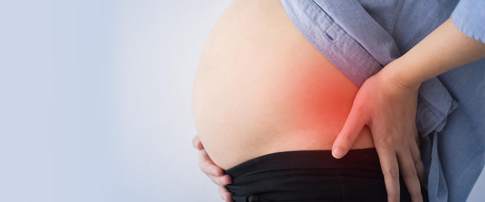 Woman having back pain during pregnancy