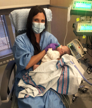 Mom Amy holds baby Miles, who was born vein of Galen malformation