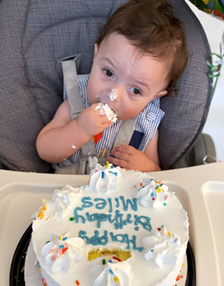 Miles, who was born vein of Galen malformation, eats cake on his first birthday