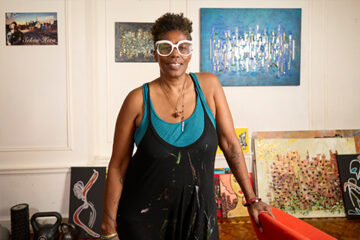 Artist Julia Kito Kirtley at her home in Brooklyn with art around her