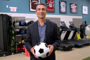 Dr. Christopher Ahmad holds soccer ball