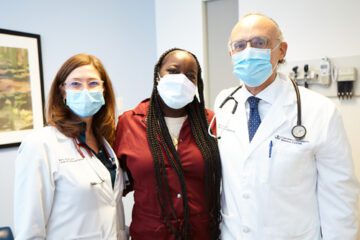 Dr. Kelly Axsom, Rachel Harper, and Dr. Paolo Colombo posing in an examination room