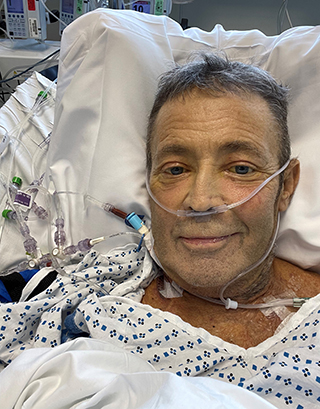 Triple transplant recipient Jerry Cahill in a hospital bed.