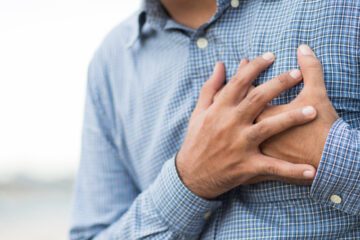 Person clutching their chest in pain.