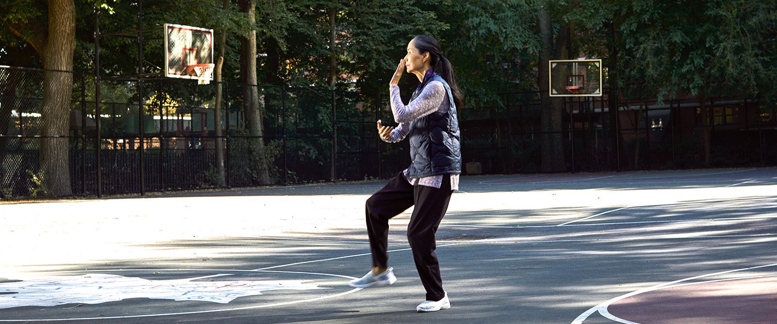Woman doing tai chi in a park
