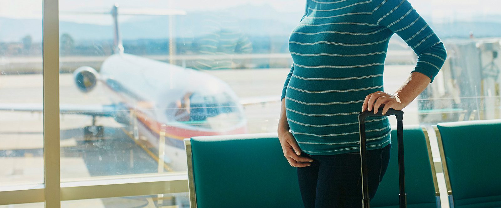 pregnant woman in airport, traveling while pregnant