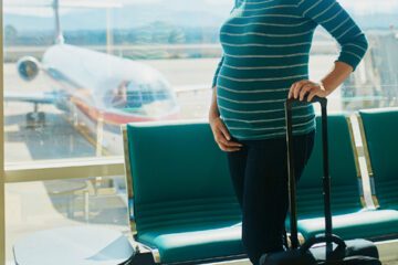 pregnant woman in airport traveling while pregnant