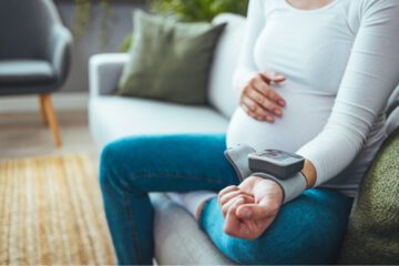 pregnant woman with blood pressure cuff