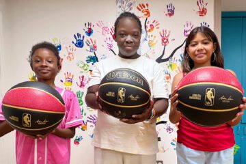 Three children hold a special-edition sickle cell ball