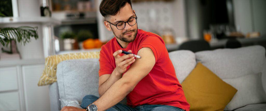 A man giving himself an insulin injection