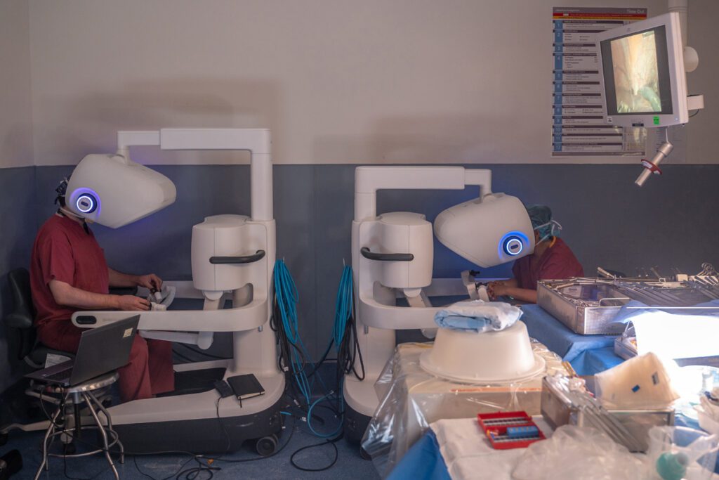 Dr. Jason Hawksworth, surgical director of adult liver transplantation and chief of hepatobiliary surgery at NewYork-Presbyterian/Columbia, and transplant surgeon Dr. Nathaly Llore, work on robotic consoles to robotically explanted a living donor’s liver.
