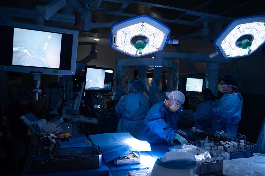 Medical professionals robotically explanting a portion of a living donor’s liver as part of the first reported living donor domino split-liver transplant in adults in the United States.
