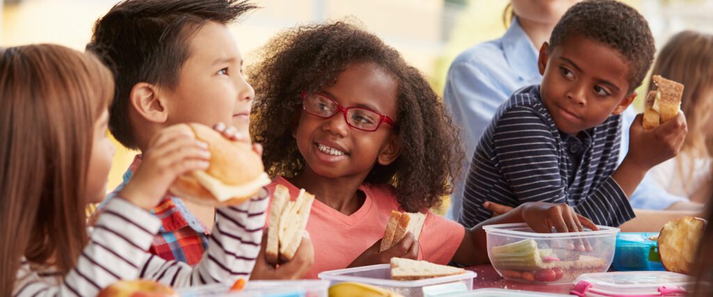 Young students eating lunch together.