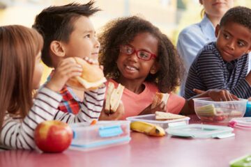 Young students eating lunch together.