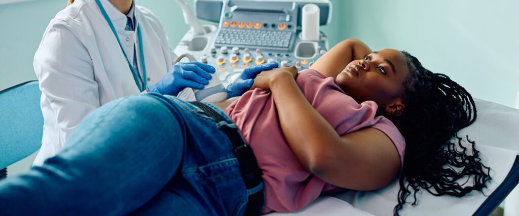 woman lying down in doctor's office getting an ultrasound 