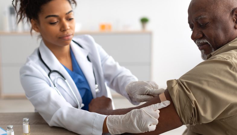 Patient receiving a shot from nurse