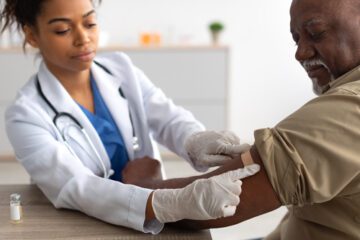 Patient receiving a shot from nurse