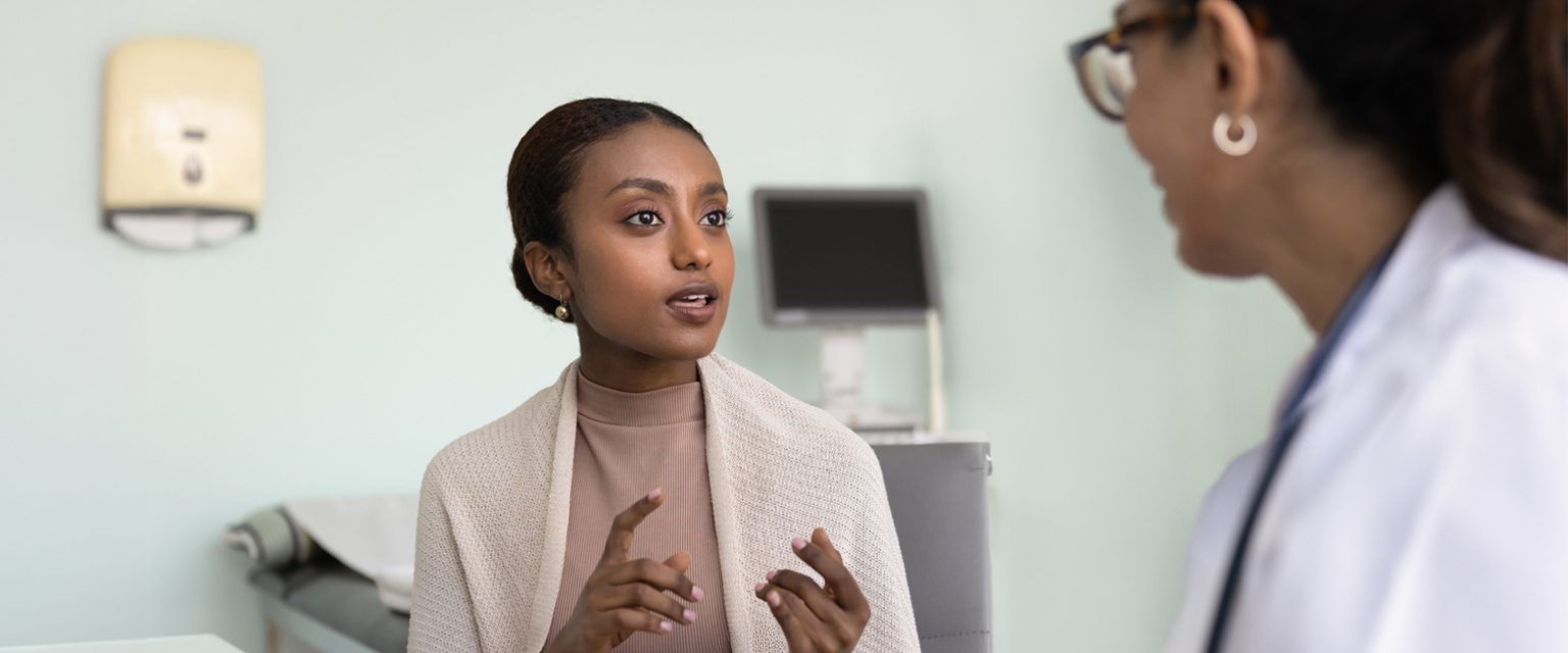 patient speaking to fertility specialist in an exam room
