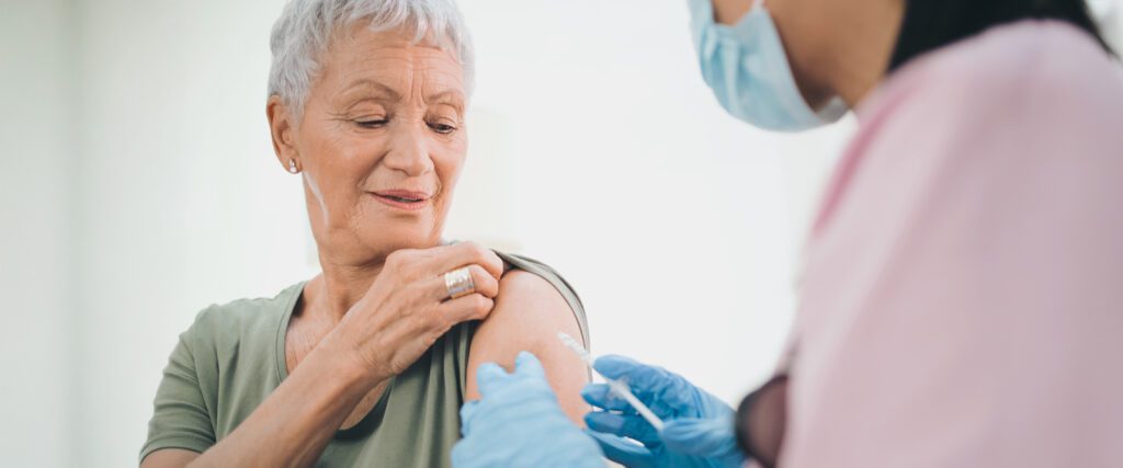 An older woman getting a vaccine.