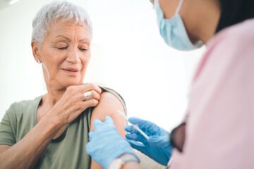 An older woman getting a vaccine.