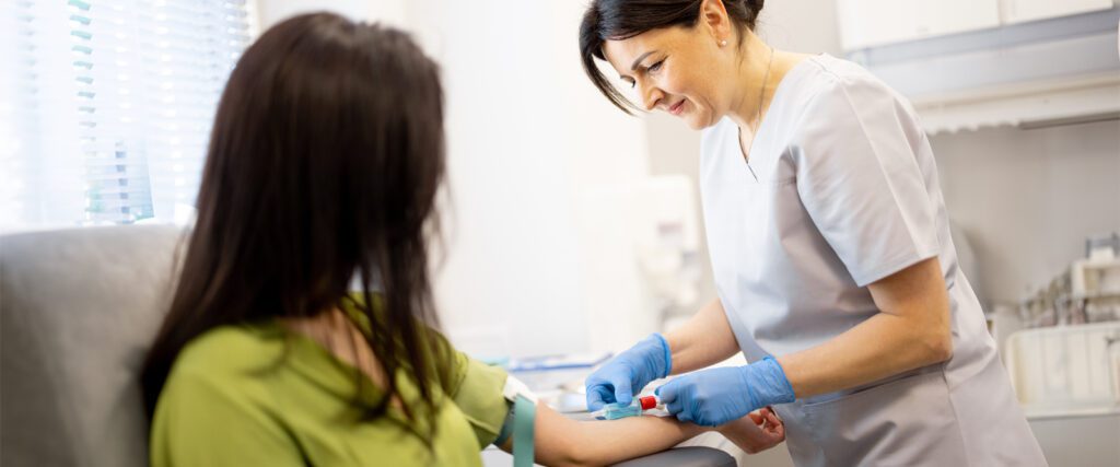 Nurse collecting blood for a cholesterol test