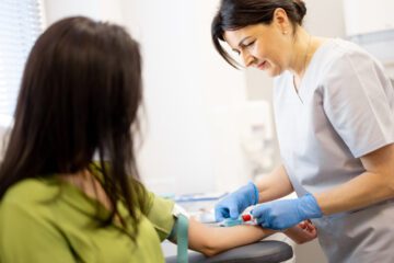 Nurse collecting blood for a cholesterol test