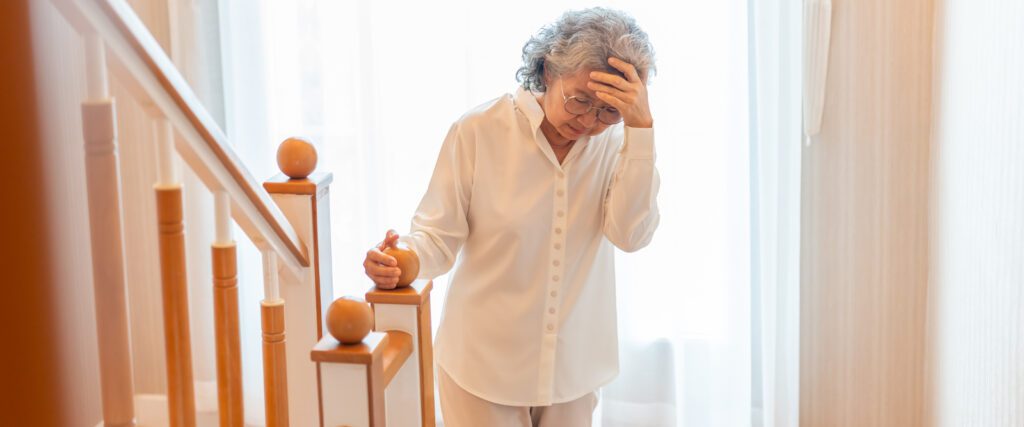 woman holding her head after a head bump
