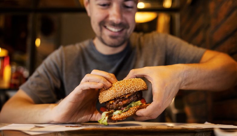 A man eating a hamburger.