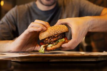 A man eating a hamburger.